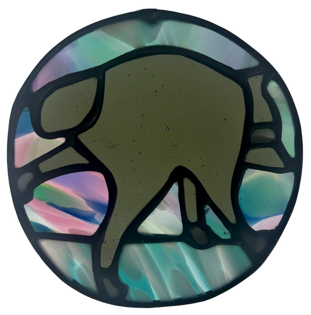 A handmade stained glass Jimothy Christmas ornament